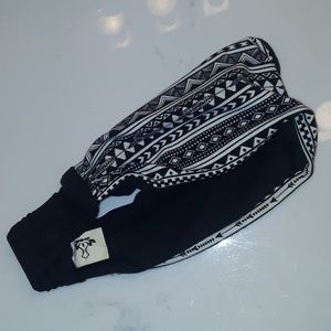 A wide black and white yoga headband